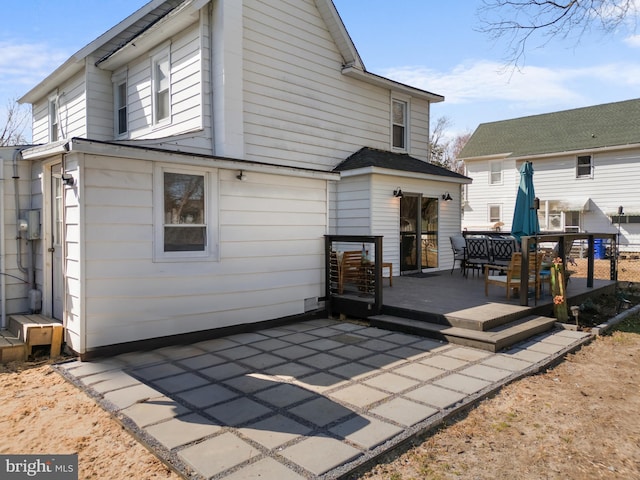 back of property featuring a patio and a deck