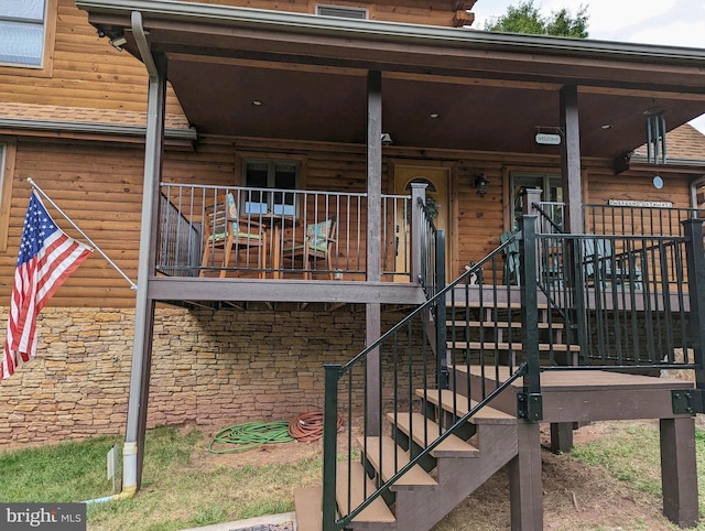 exterior space featuring covered porch and stone siding