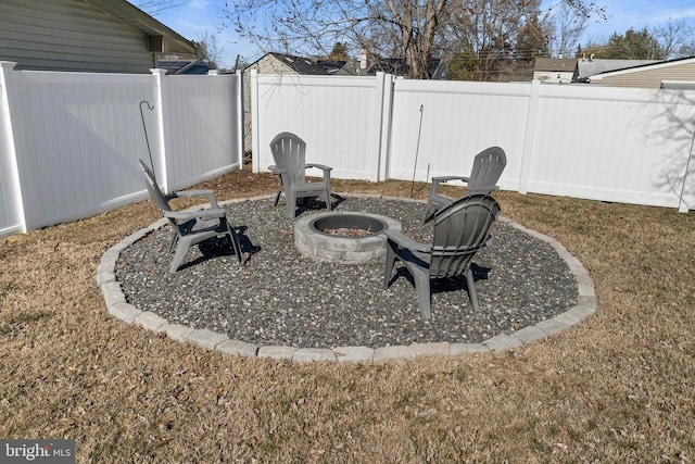 view of yard featuring fence and an outdoor fire pit