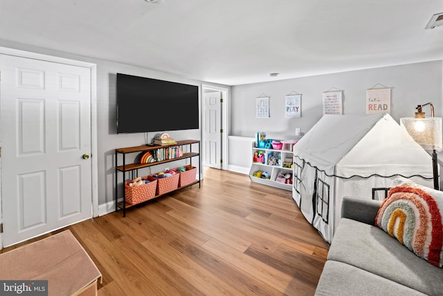 recreation room with wood finished floors and baseboards