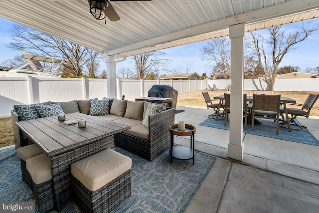 view of patio / terrace featuring outdoor dining area, an outdoor hangout area, area for grilling, and a fenced backyard