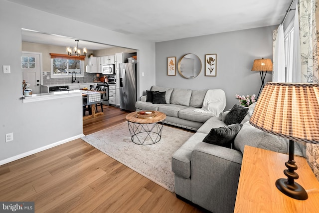 living area featuring a chandelier and wood finished floors