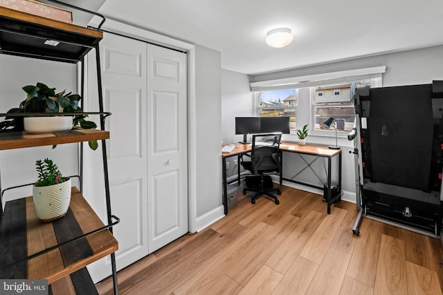 home office featuring baseboards and light wood finished floors