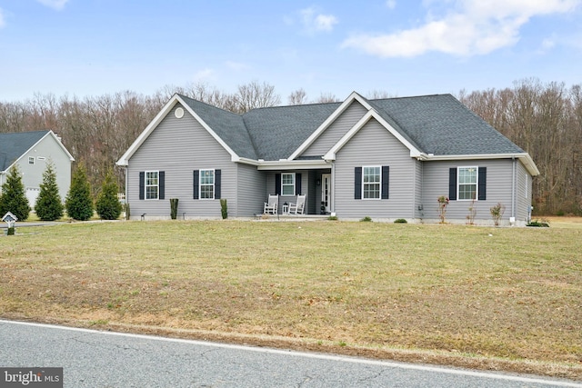 ranch-style home featuring a front yard and a shingled roof