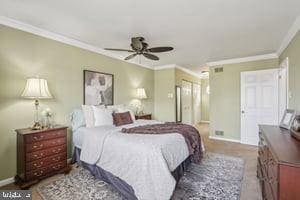 bedroom with ceiling fan, baseboards, and ornamental molding