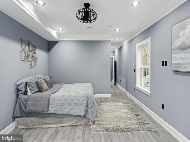 bedroom featuring recessed lighting, baseboards, wood finished floors, and ornamental molding