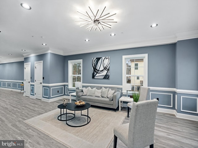 living room with light wood finished floors, recessed lighting, and wainscoting