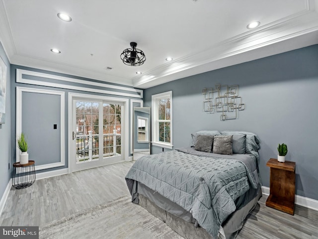 bedroom with access to outside, wood finished floors, baseboards, and ornamental molding