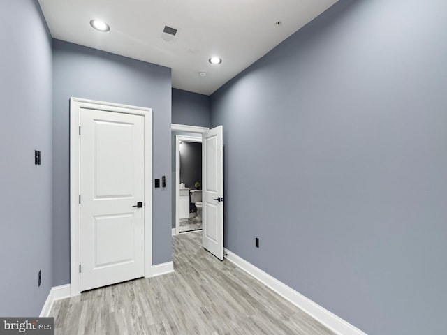 unfurnished room featuring recessed lighting, baseboards, visible vents, and light wood finished floors