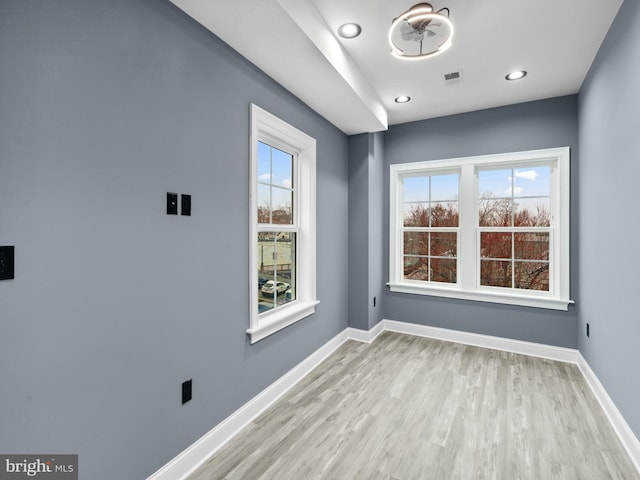 spare room with visible vents, recessed lighting, wood finished floors, and baseboards