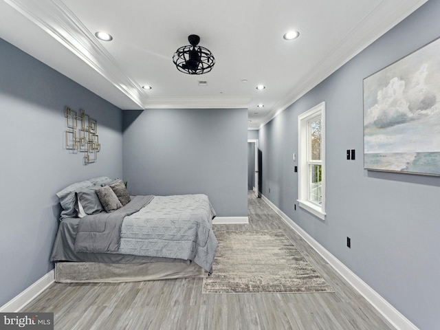 bedroom with crown molding, recessed lighting, wood finished floors, and baseboards