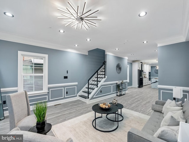 living room featuring stairway, recessed lighting, and ornamental molding