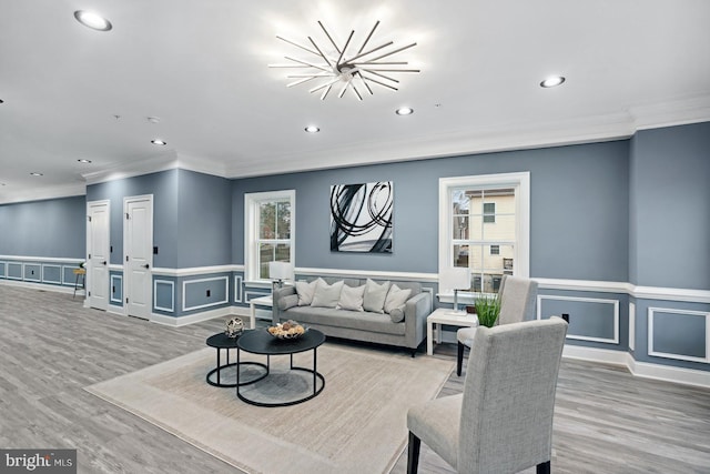 living room with crown molding, recessed lighting, and light wood finished floors