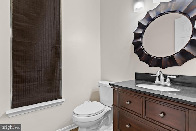 bathroom featuring toilet and vanity