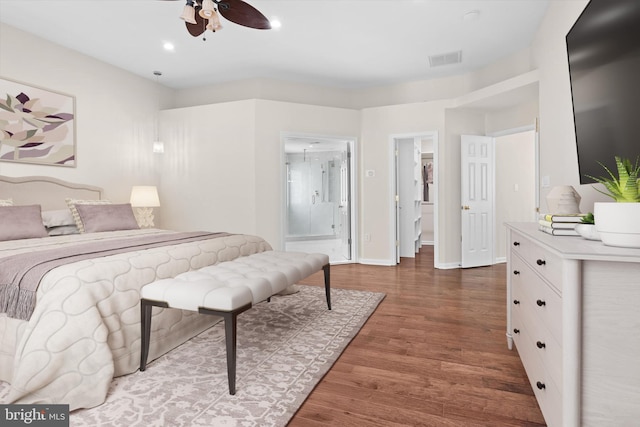 bedroom featuring visible vents, connected bathroom, baseboards, recessed lighting, and wood finished floors