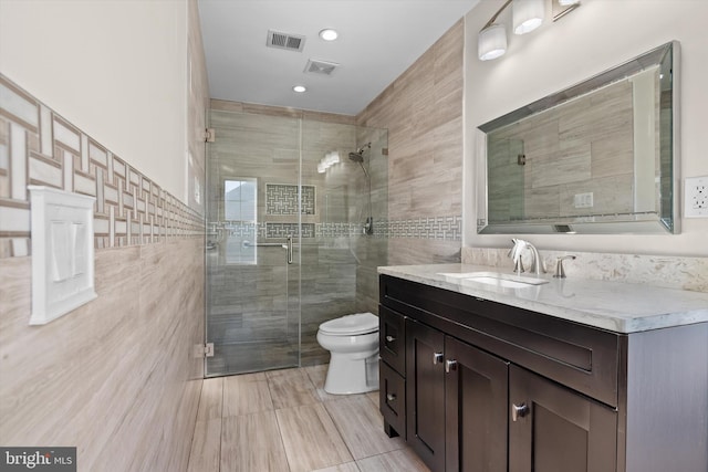 full bathroom featuring visible vents, toilet, tile walls, and a stall shower