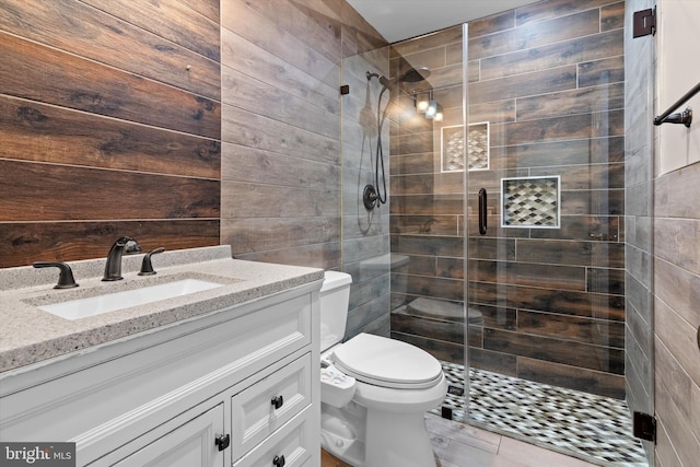 bathroom featuring a shower stall, toilet, and vanity