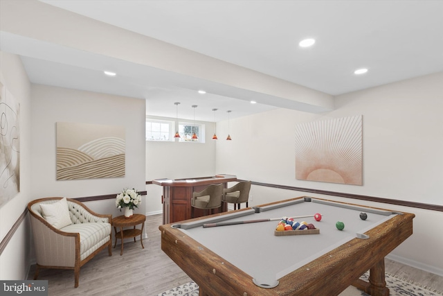 recreation room featuring a dry bar, recessed lighting, light wood-type flooring, and baseboards