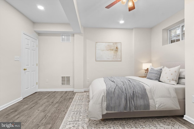 bedroom with visible vents, recessed lighting, baseboards, and wood finished floors