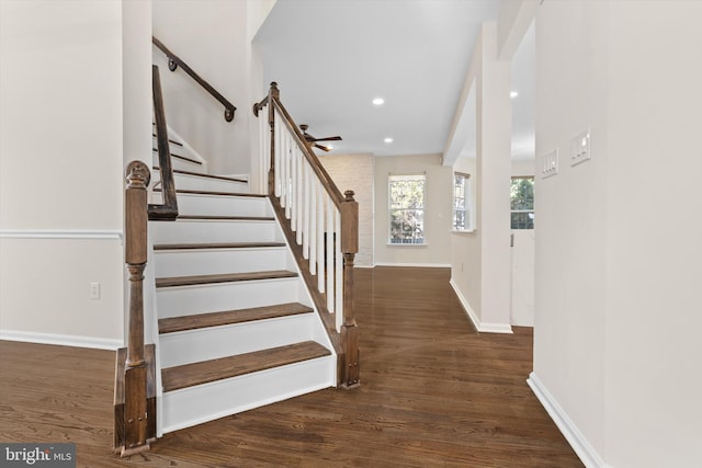 stairway featuring recessed lighting, wood finished floors, and baseboards