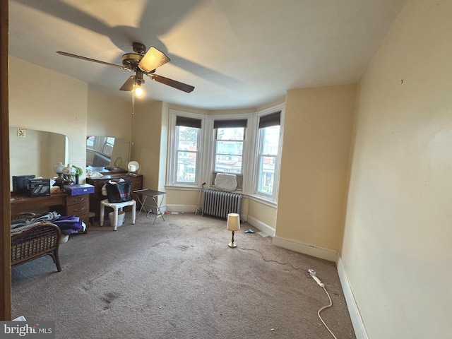 miscellaneous room with carpet flooring, ceiling fan, radiator heating unit, and baseboards