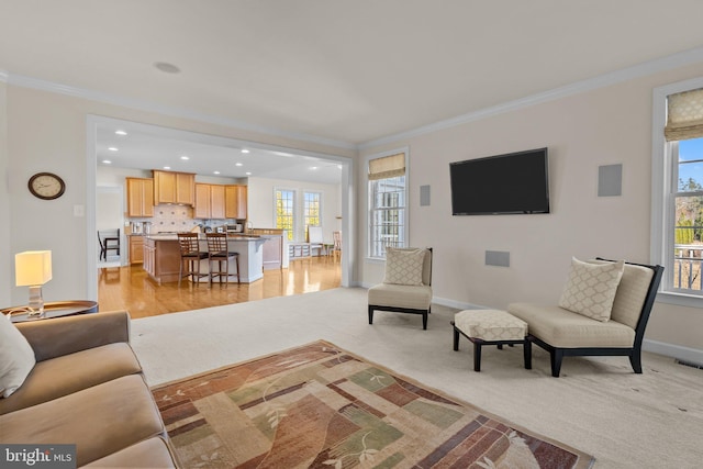 living room featuring visible vents, baseboards, light colored carpet, and ornamental molding