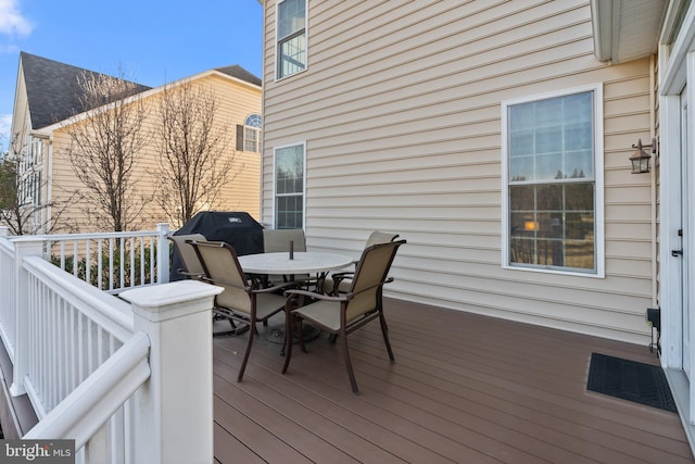 wooden deck featuring outdoor dining area