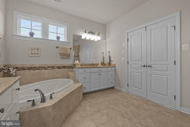 full bathroom with vanity, a bath, tile patterned flooring, and tiled shower