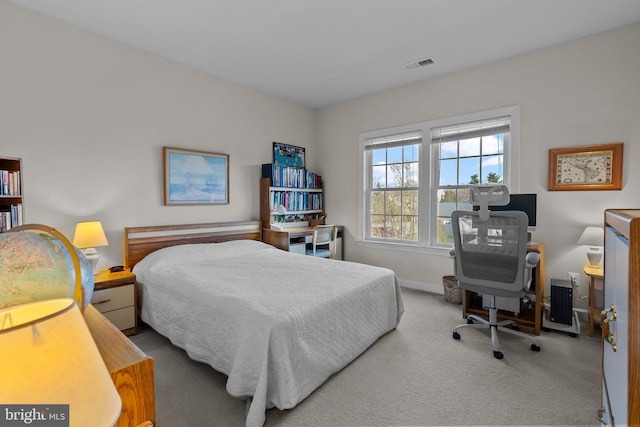 carpeted bedroom featuring visible vents and baseboards