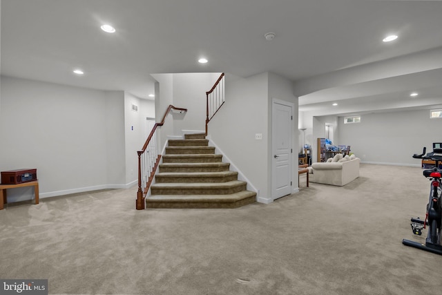 below grade area featuring recessed lighting, baseboards, and carpet