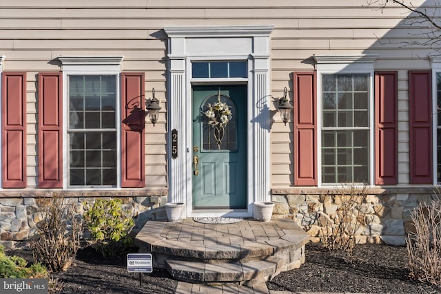 property entrance with stone siding