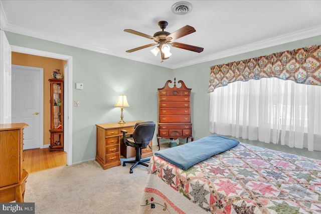 bedroom with visible vents, light carpet, crown molding, baseboards, and ceiling fan