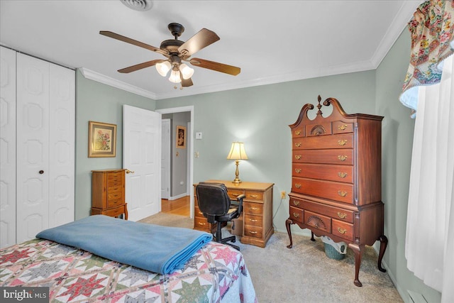 bedroom with a closet, a ceiling fan, carpet, and ornamental molding