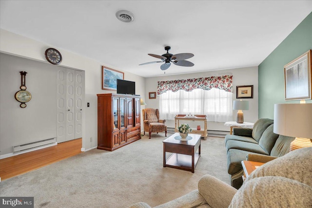 carpeted living area featuring visible vents, baseboard heating, a baseboard heating unit, and ceiling fan