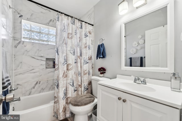 bathroom with vanity, toilet, and shower / bath combo