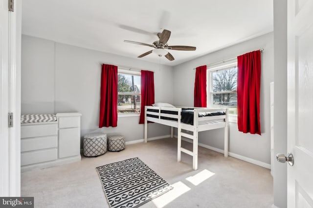 bedroom featuring baseboards, multiple windows, and a ceiling fan