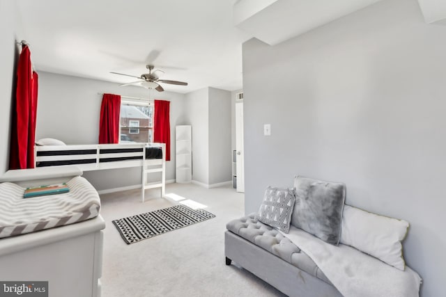 carpeted bedroom featuring baseboards and ceiling fan