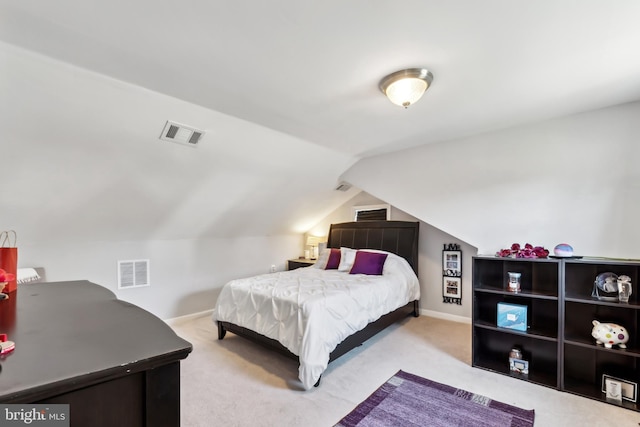 bedroom featuring visible vents, baseboards, lofted ceiling, and carpet