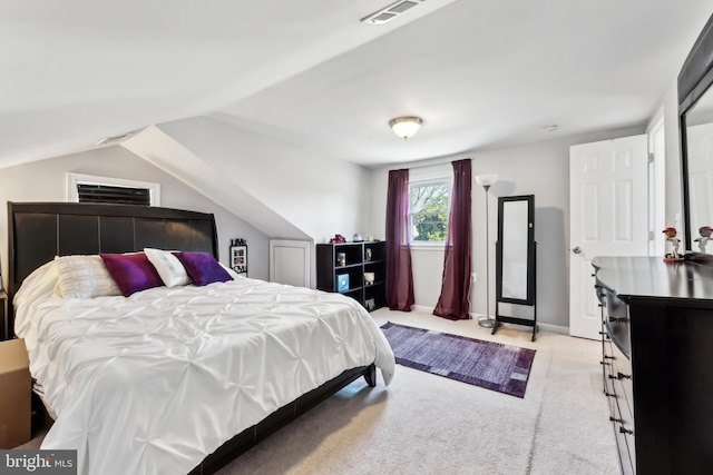 bedroom featuring lofted ceiling, light colored carpet, visible vents, and baseboards