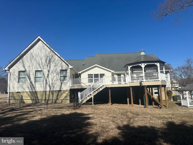 rear view of property with a gazebo, stairway, fence, and a wooden deck