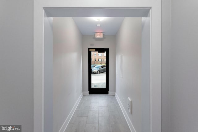 doorway to outside with baseboards