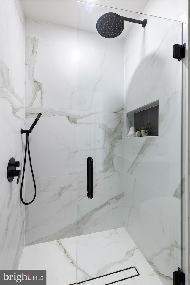 full bathroom featuring a marble finish shower