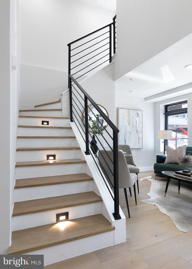 stairs with baseboards and wood finished floors