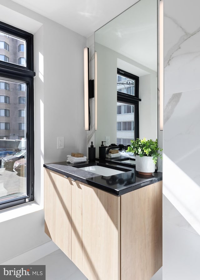 interior space with dark countertops, modern cabinets, and light brown cabinets