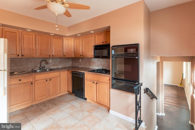 kitchen featuring backsplash, black appliances, a warming drawer, a ceiling fan, and a sink