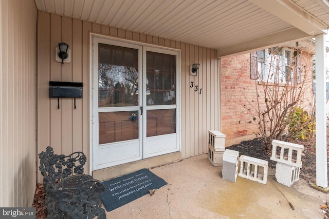 doorway to property with brick siding