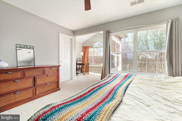 bedroom featuring visible vents, lofted ceiling, ceiling fan, and carpet flooring