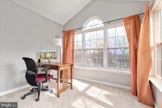 carpeted office space featuring a wealth of natural light, baseboards, and lofted ceiling