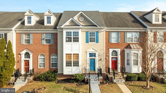 townhome / multi-family property featuring brick siding