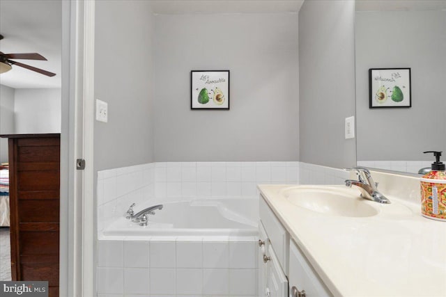 full bath with vanity, a bath, and a ceiling fan